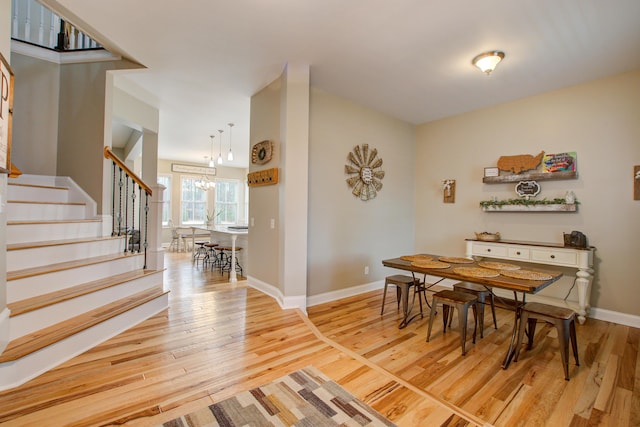 1129 Plantation Overlook Dr, Moncks Corner, SC 29461 - dining room with stairway, light wood-type flooring, and a chandelier