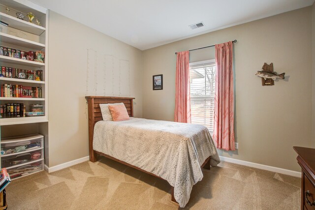 bedroom featuring light carpet