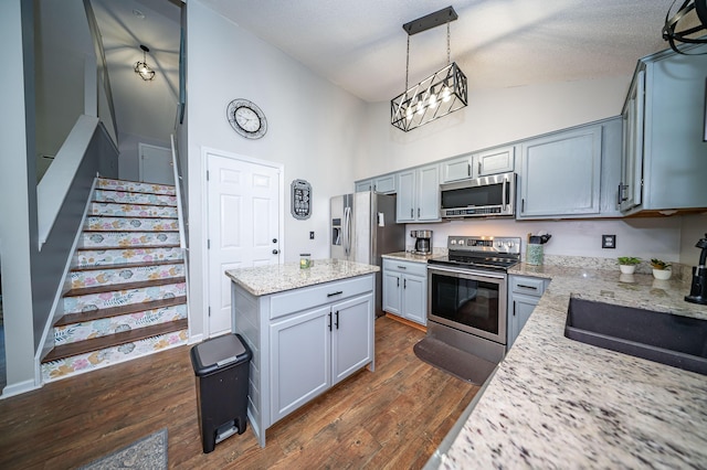 229 Lindy Creek Rd, Goose Creek, SC 29445 - kitchen with appliances with stainless steel finishes, dark wood-type flooring, a kitchen island, decorative light fixtures, and high vaulted ceiling