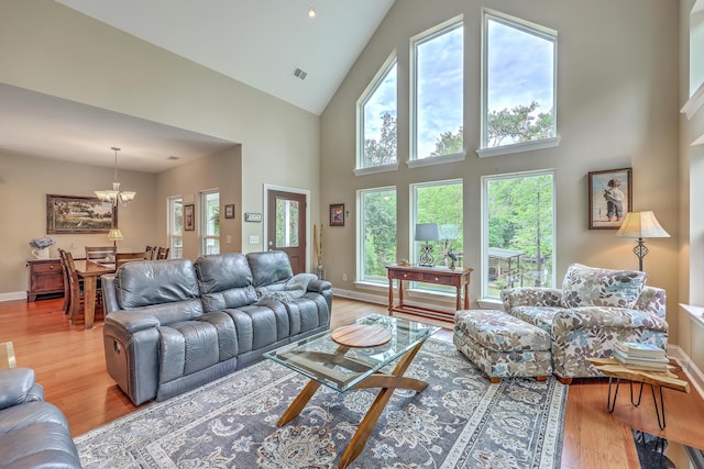 100 Canal Rd, Saint George, SC 29477 - living room with wood finished floors, a chandelier, a high ceiling, and baseboards