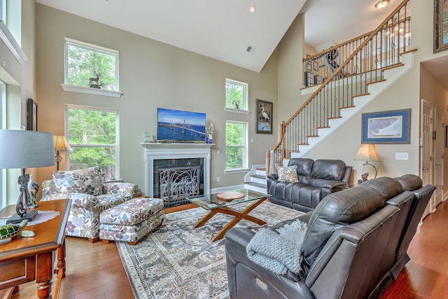 100 Canal Rd, Saint George, SC 29477 - living area with high vaulted ceiling, stairway, hardwood / wood-style flooring, a fireplace with flush hearth, and baseboards