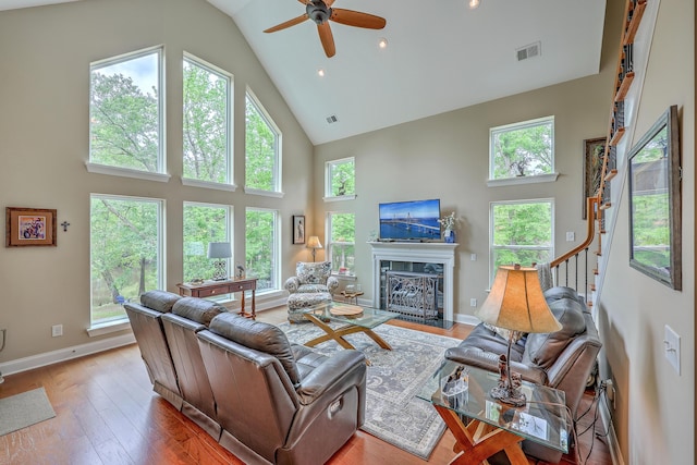 100 Canal Rd, Saint George, SC 29477 - living room featuring high vaulted ceiling, ceiling fan, a fireplace with flush hearth, hardwood / wood-style floors, and baseboards