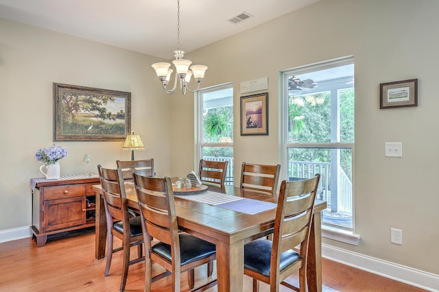 100 Canal Rd, Saint George, SC 29477 - dining room featuring light wood-style flooring, a chandelier, and baseboards
