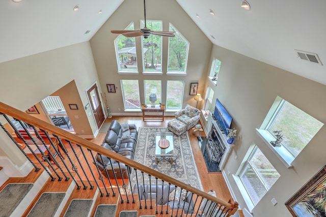 100 Canal Rd, Saint George, SC 29477 - living room featuring high vaulted ceiling, wood finished floors, baseboards, a ceiling fan, and stairs