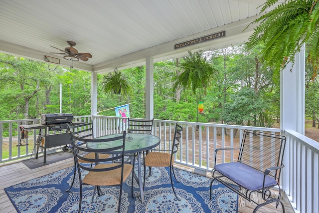 100 Canal Rd, Saint George, SC 29477 - wooden terrace featuring outdoor dining area, a ceiling fan, grilling area, and view of wooded area