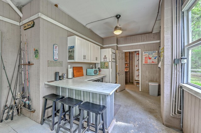 100 Canal Rd, Saint George, SC 29477 - kitchen featuring light countertops, white cabinets, ceiling fan, a kitchen breakfast bar, and a peninsula