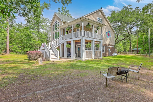 100 Canal Rd, Saint George, SC 29477 - back of house featuring a fire pit, stairway, a yard, a wooden deck, and roof with shingles