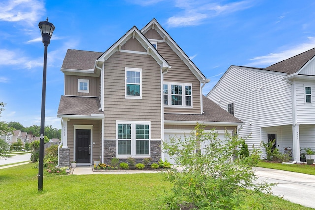 9998 Winged Elm St, Ladson, SC 29456 - view of front facade with a front yard, roof with shingles, stone siding, and board and batten siding