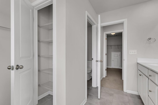 9998 Winged Elm St, Ladson, SC 29456 - bathroom featuring toilet, tile patterned flooring, baseboards, and a spacious closet