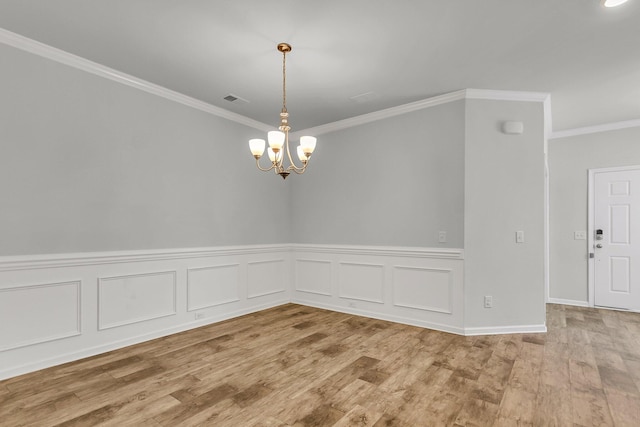 9998 Winged Elm St, Ladson, SC 29456 - spare room featuring ornamental molding, a chandelier, wood finished floors, and wainscoting