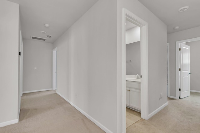 9998 Winged Elm St, Ladson, SC 29456 - hallway featuring light carpet, baseboards, and a sink