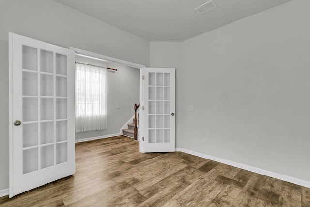 9998 Winged Elm St, Ladson, SC 29456 - unfurnished room with wood finished floors, french doors, stairs, and baseboards
