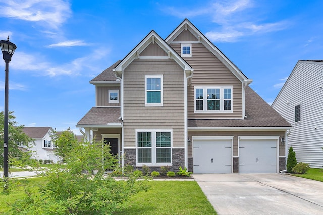 9998 Winged Elm St, Ladson, SC 29456 - craftsman-style house with concrete driveway, roof with shingles, a garage, stone siding, and board and batten siding