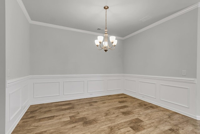 9998 Winged Elm St, Ladson, SC 29456 - spare room with crown molding, a chandelier, a wainscoted wall, wood finished floors, and a decorative wall