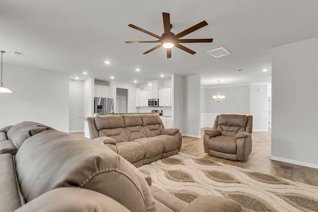 9998 Winged Elm St, Ladson, SC 29456 - living room with a chandelier, a ceiling fan, light wood-type flooring, recessed lighting, and crown molding