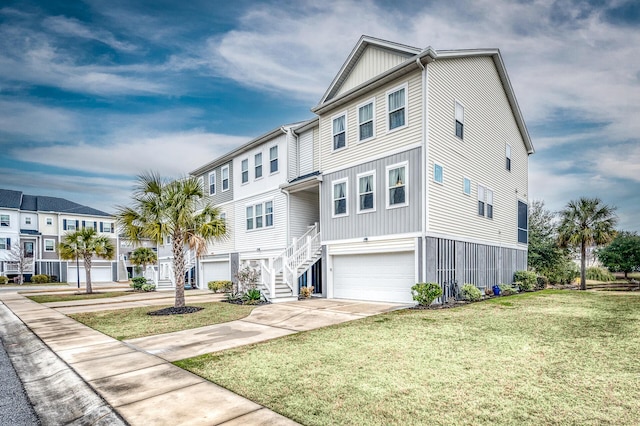 townhome / multi-family property featuring a garage and a front yard