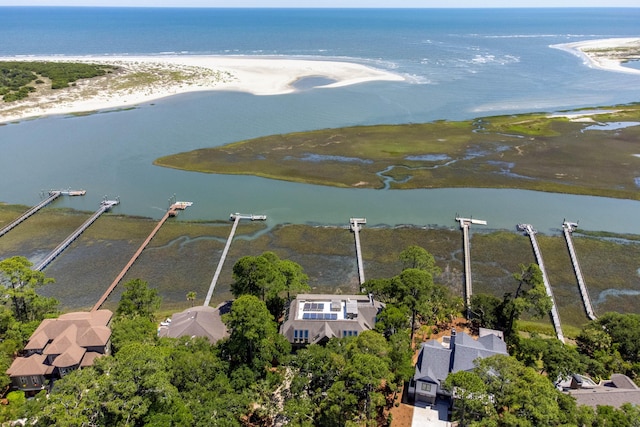 birds eye view of property with a water view and a view of the beach