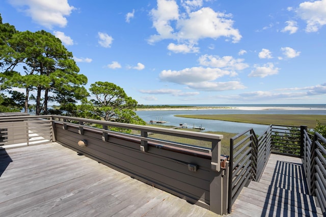 wooden terrace featuring a water view