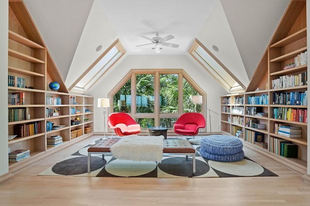 living area with ceiling fan, lofted ceiling, and light wood-type flooring