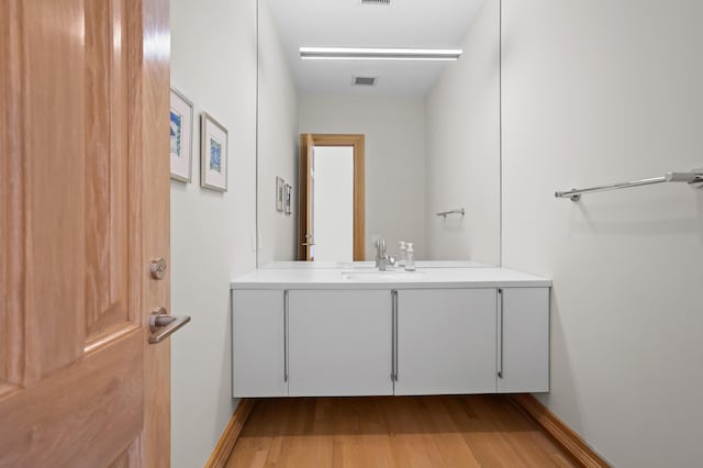 bathroom featuring hardwood / wood-style floors and vanity