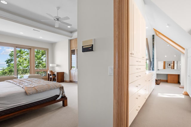 bedroom with ceiling fan, light colored carpet, and a raised ceiling