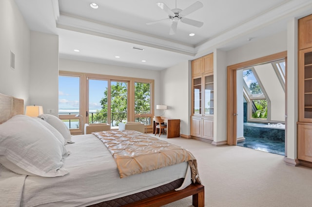 bedroom featuring ceiling fan, access to exterior, light colored carpet, and a raised ceiling