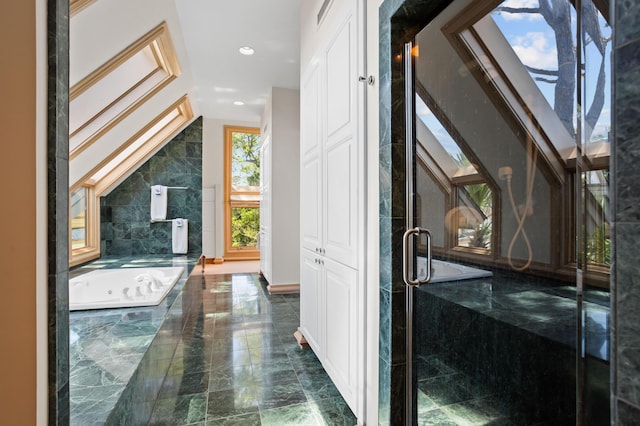 bathroom featuring a relaxing tiled tub