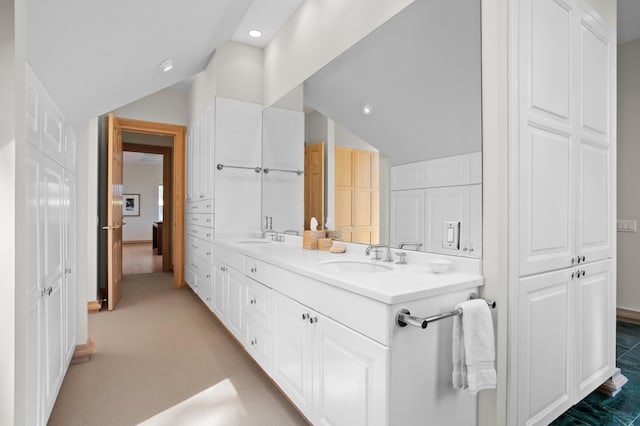 bathroom with vanity and vaulted ceiling