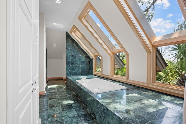 bathroom with a relaxing tiled tub