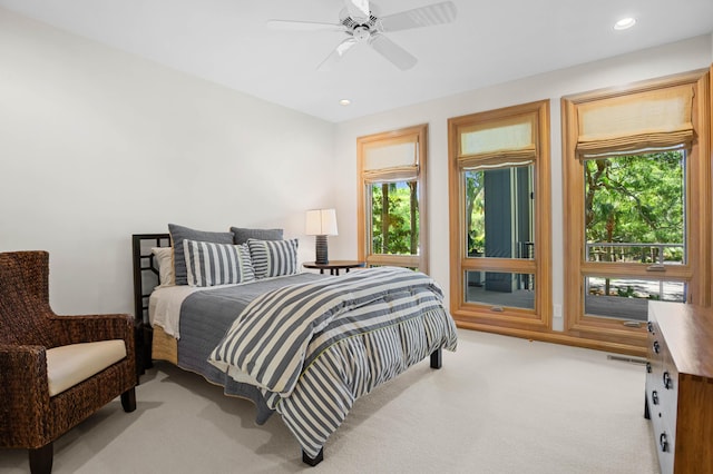 bedroom with light carpet and ceiling fan