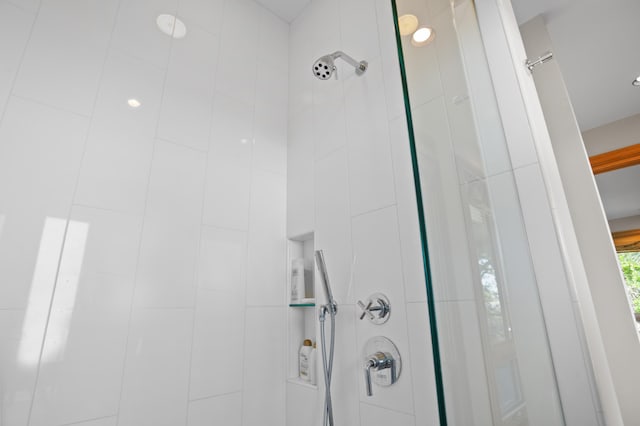 interior details featuring a tile shower