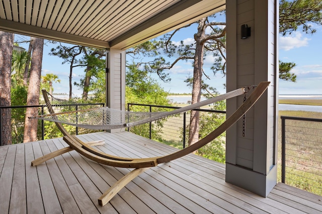 wooden terrace featuring a water view