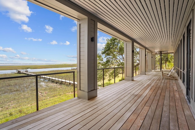 wooden terrace featuring a water view