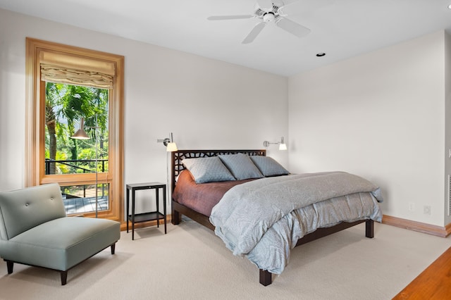 carpeted bedroom with ceiling fan and multiple windows