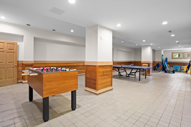 game room featuring wood walls