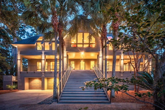 view of front facade featuring a garage and a balcony