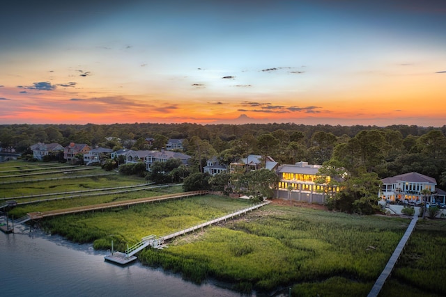 aerial view at dusk with a water view