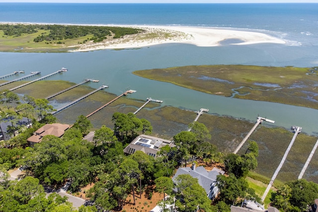 drone / aerial view with a water view and a beach view