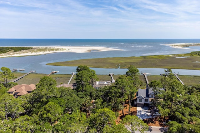 birds eye view of property featuring a water view and a beach view