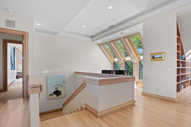 stairway featuring wood-type flooring and built in features