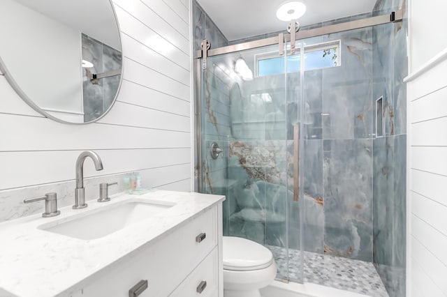 bathroom featuring vanity, wood walls, a marble finish shower, and toilet