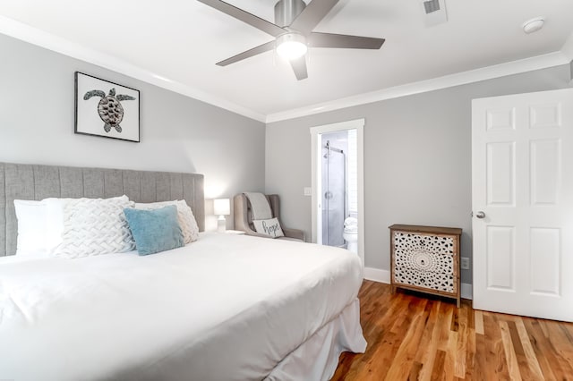 bedroom with light wood finished floors, visible vents, connected bathroom, ceiling fan, and ornamental molding