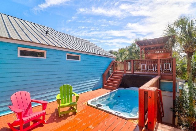 wooden deck with a pergola and hot tub deck surround