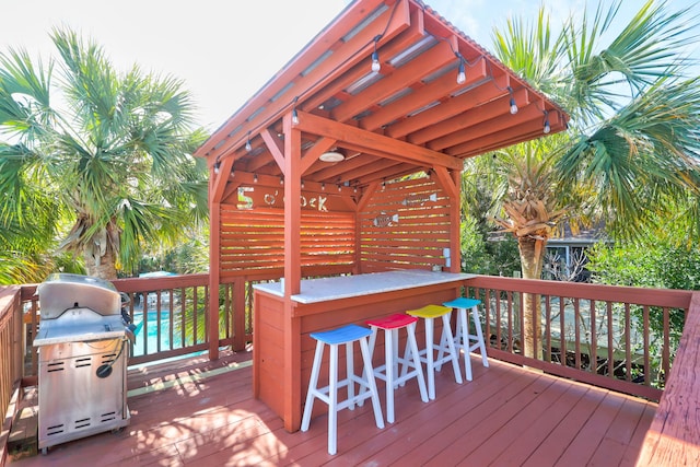 wooden deck featuring outdoor dry bar and grilling area