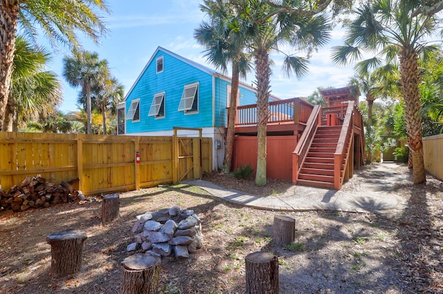 exterior space featuring a fenced backyard, a wooden deck, and stairs