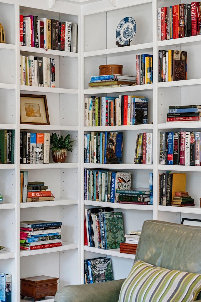 living area featuring wall of books