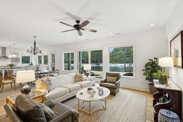 living area with visible vents, light wood-style flooring, and a wealth of natural light