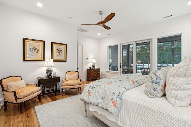 bedroom featuring access to outside, visible vents, wood finished floors, and recessed lighting