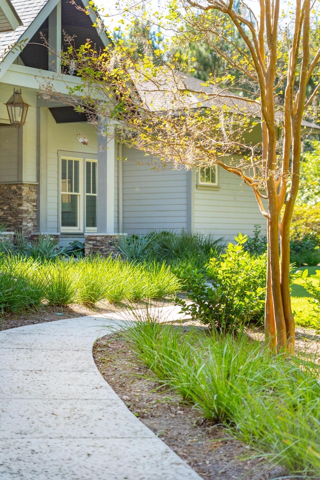 view of side of home featuring stone siding