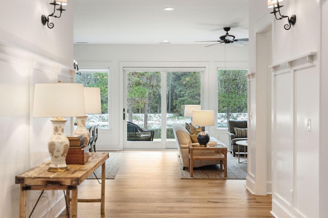 sunroom / solarium featuring a ceiling fan